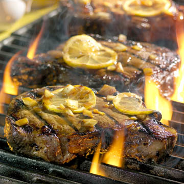 steaks on grill with fire - food photography
